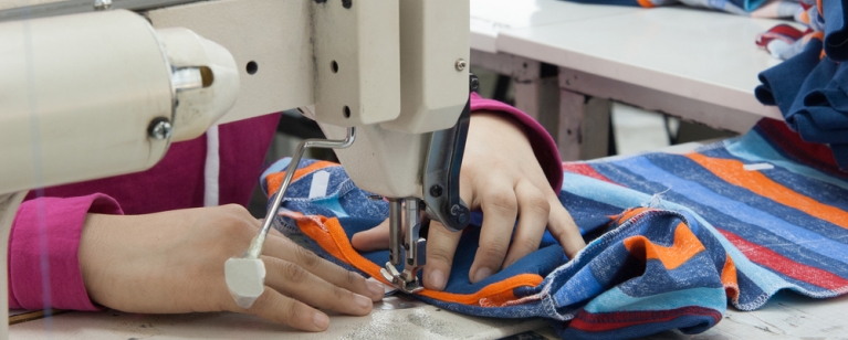Garment worker, using sewing machine