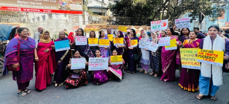 Women garment workers hold up signs ahead of a march for International Women's Day in Dhaka, Bangladesh. Photo credit: ETI Bangladesh.