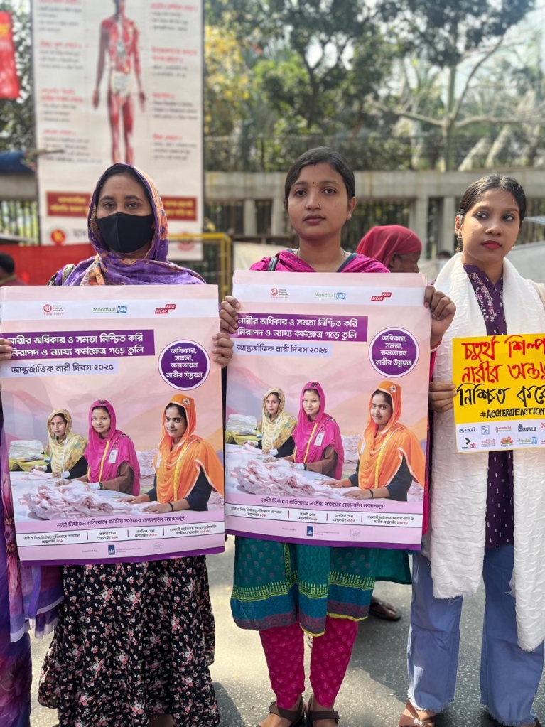 Women garment workers host up awareness raising posters at a march for International Women's Day in Dhaka, Bangladesh. Photo credit: ETI Bangladesh.