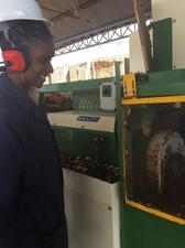 A woman ‘pezzolato’ machine operator operates the machine that turns these logs into timber.