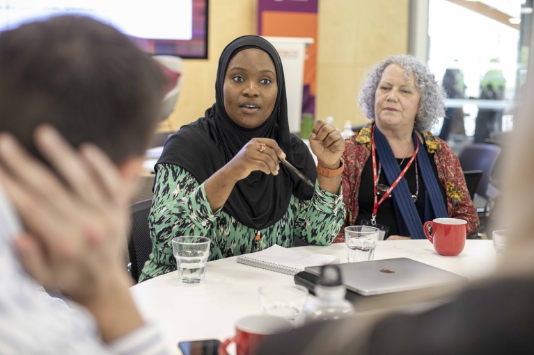 ETI staff and members engage in conversation. Photo credit: Shutterstock.