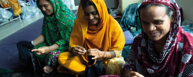 Female garment workers, smiling