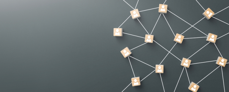 Wooden blocks connected together on blue background. Teamwork, network and community concept. Photo credit: Shutterstock.