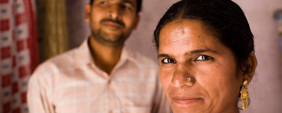 Female homeworker and her husband, behind. India.