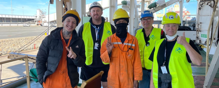 Seafarers pose for a photo with smiles and thumbs up. Photo credit: ITF.