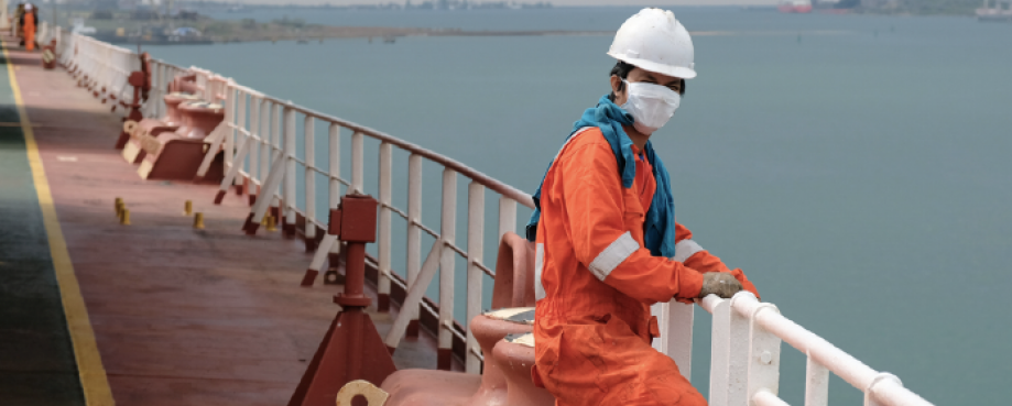 Seafarer in hardhat and face mask