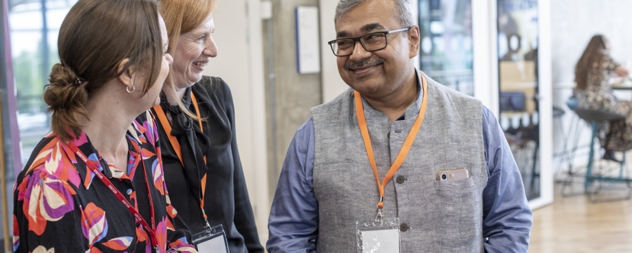 ETI members and colleague talking and smiling. Photo credit: ETI.