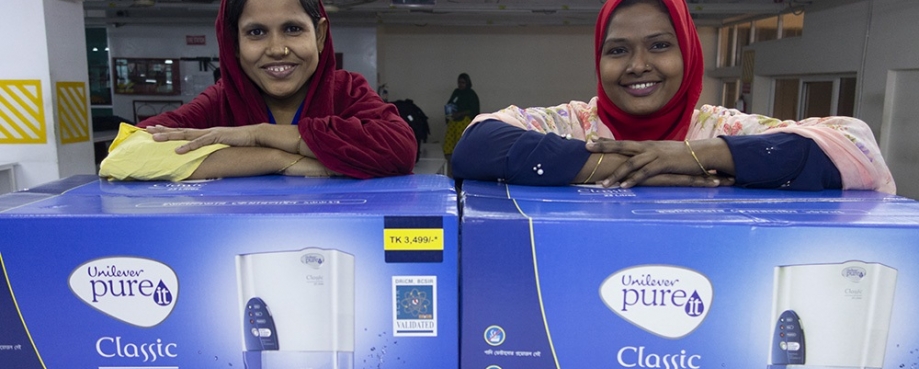 Female overseas workers receive water filters from ONE+ALL.