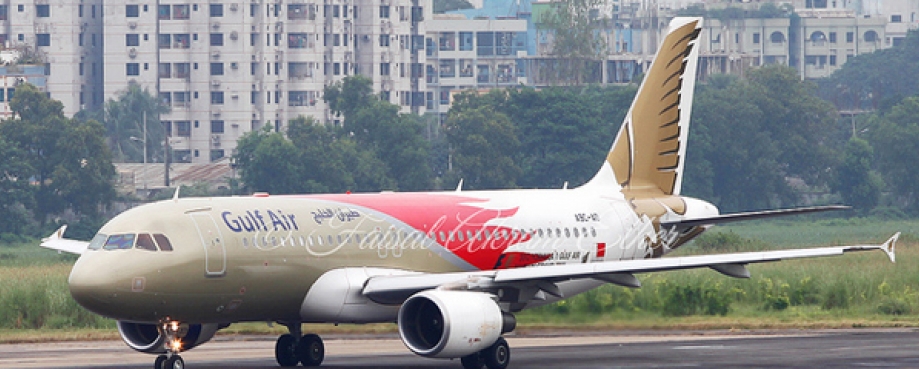 Plane on Dhaka airport runway, with high-rise buildings in background