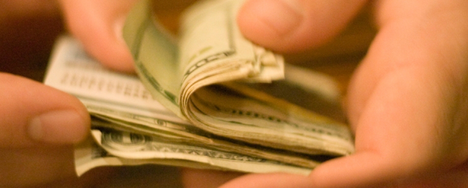 Folded cash in hands