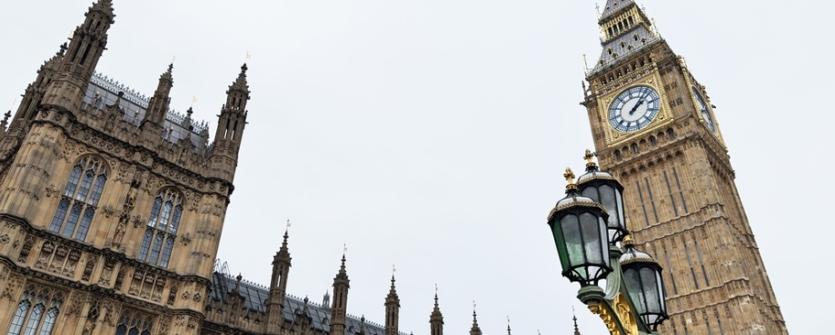 Dramatic view of Big Ben and the Gothic Houses of Parliament with an ornate street lamp in London, UK. Photo credit: Shutterstock.