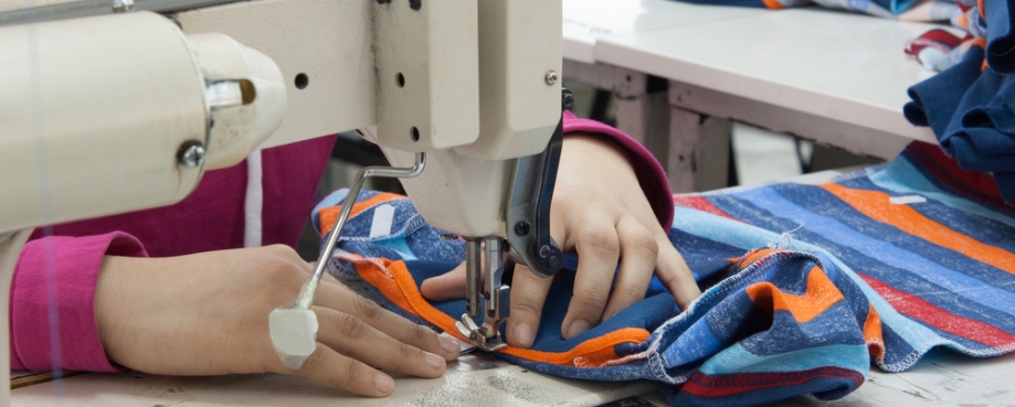 Garment worker, using sewing machine