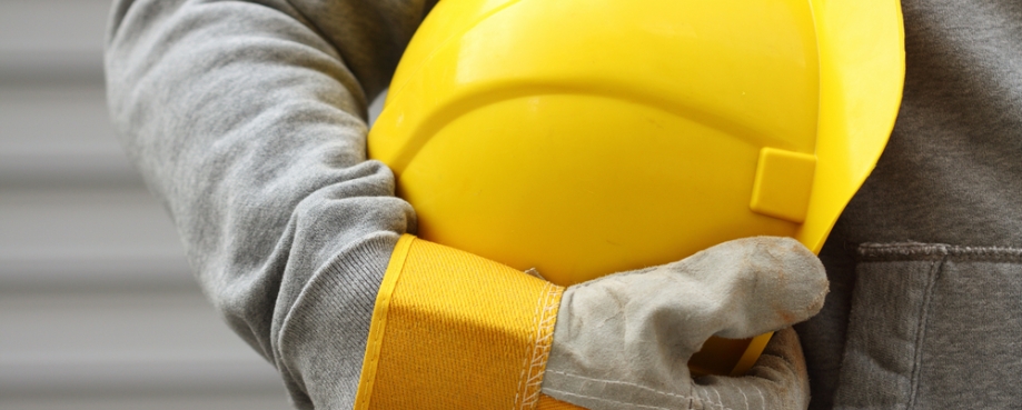 Worker holding helmet