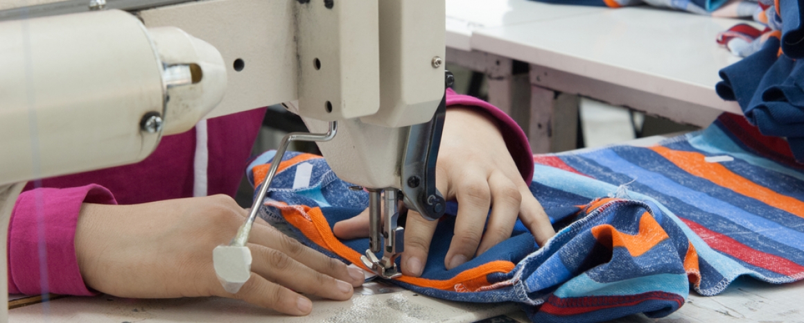 Garment worker, using sewing machine