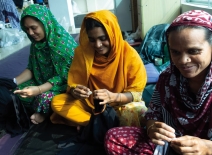 Female garment workers, smiling