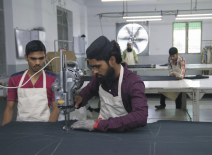 Two garment workers operating a sewing machine. Photo credit: The Parently Group.