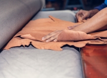 Leather being pass through a press. Photo credit: FNV.