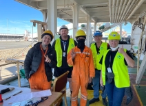 Seafarers pose for a photo with smiles and thumbs up. Photo credit: ITF.