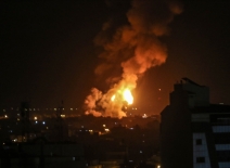 Fires erupt from a building following an airstrike. Photo credit: Shutterstock.