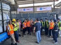 A group of workers stands together at a Prevented Ocean Plastic collection centre.