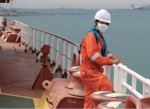 Seafarer in hardhat and face mask