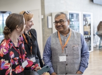 ETI members and colleague talking and smiling. Photo credit: ETI.