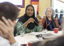 ETI staff and members engage in conversation. Photo credit: Shutterstock.
