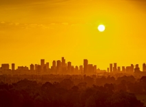 Low sun over a polluted urban skyline