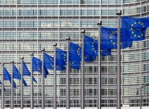 Row of EU Flags in front of the European Union Commission building in Brussels. Photo credit: VanderWolf/ Shutterstock.