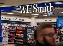 London, United Kingdom - February 05, 2019: Unknown man walks in front of WHSmith branch at London Luton airport. WHS is major British retailer selling mostly books, stationery, magazines & newspapers. Photo credit: Lubo Ivanko, Shutterstock.