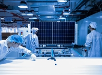 Factory workers lifting new solar panel from production line,and the technician is checking it in the factory, China. Photo credit: Shutterstock.