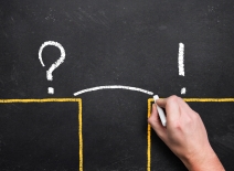 Hand sketching a bridge over the gap between problem and solution.Photo credit: Shutterstock.
