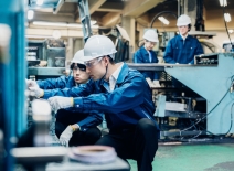 Factory workers in Korea, servicing machinery