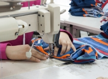 Garment worker, using sewing machine