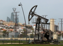 Oil pumpjack in seaside park overlooking the Baku skyline where COP29 is taking place. Photo credit: Shutterstock.