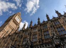 A photograph of the houses of parliament looking up at Big Ben's clockface and a blue sky with wisps of cloud. Photo credit: Shutterstock.