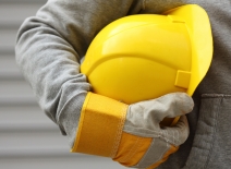 Worker holding helmet