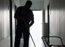 Male cleaner, mopping a floor